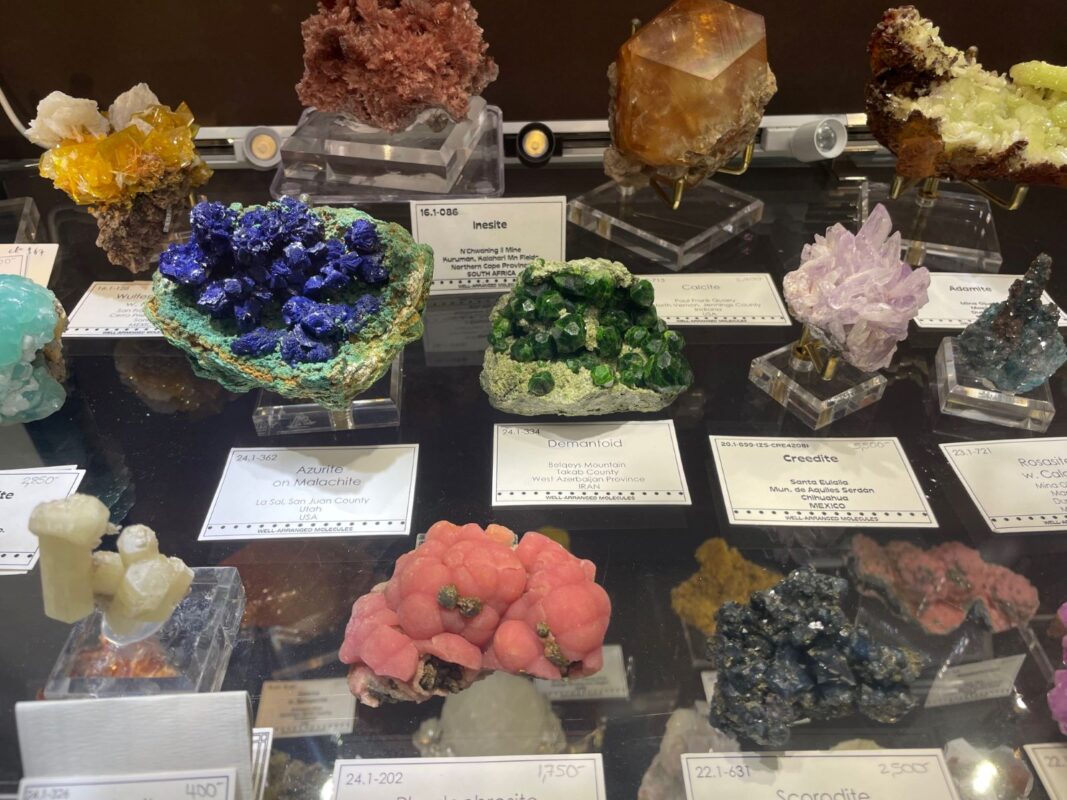 Colourful selection of mineral specimens at Well Arranged Molecules’ room Tucson 2025 Colourful selection of mineral specimens at Well Arranged Molecules' room Tucson 2025